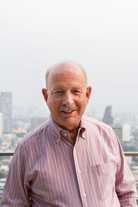 Portrait of man standing against sea