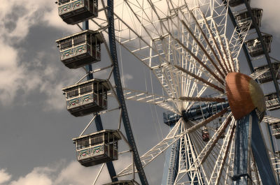 Low angle view of ferris wheel against sky