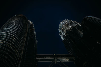 Low angle view of illuminated buildings against sky at night