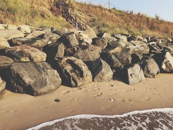 View of rocks on beach against sky