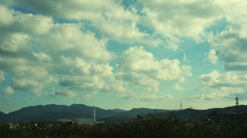 Scenic view of mountains against cloudy sky