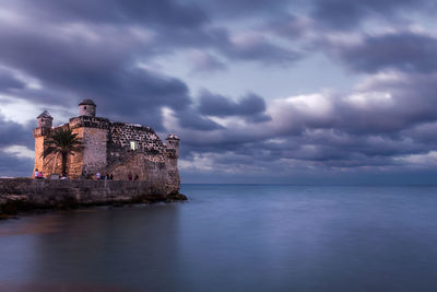 Scenic view of sea against sky at dusk