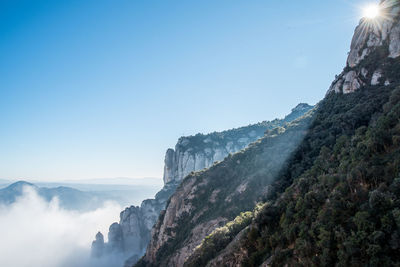 Scenic view of mountains against clear blue sky