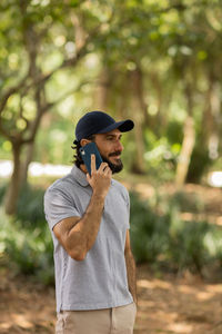 Young man at park on a beautiful sunny day with mobile phone.  working  leisure. green and nature 