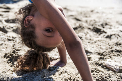 Close-up of boy on sand at beach