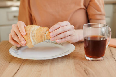 Midsection of woman having breakfast
