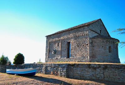 Old building against clear blue sky