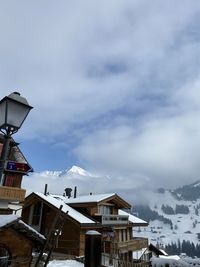 Houses and buildings against sky during winter