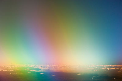 Low angle view of rainbow against sky during sunset