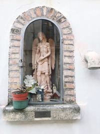 Statue of buddha against building