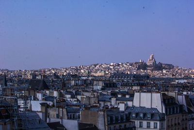 Aerial view of townscape against clear blue sky