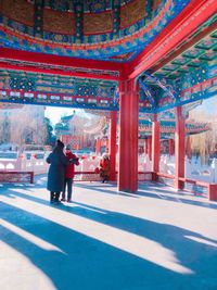 Rear view of people walking in temple building