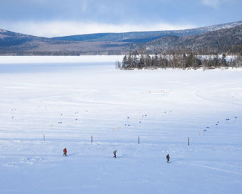People walking on the frozen akan-lake