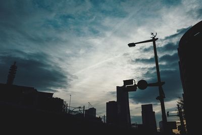 Low angle view of silhouette buildings against sky