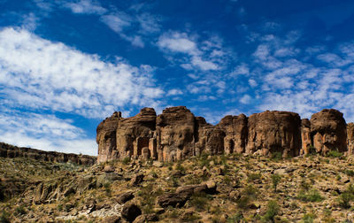 Low angle view of rock formations against sky