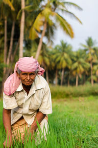 Portrait of man wearing hat on field