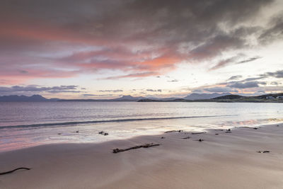 Scenic view of beach against sky during sunset