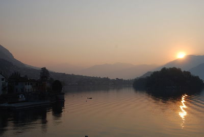 Scenic view of lake against sky during sunset