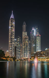 Illuminated buildings in city at night