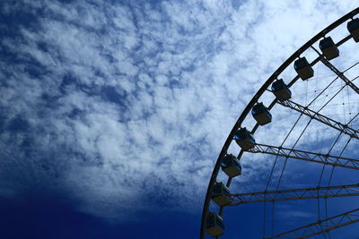 Low angle view of ferris wheel against sky