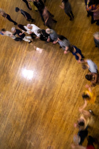 High angle view of people playing on wooden floor