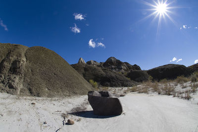 Scenic view of rocks against bright sun