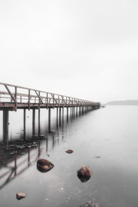 Bridge over sea against clear sky