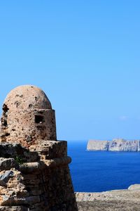 View of sea against clear blue sky