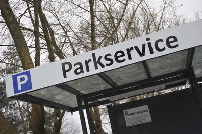 Low angle view of road sign against trees