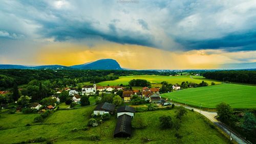 Scenic view of field against cloudy sky