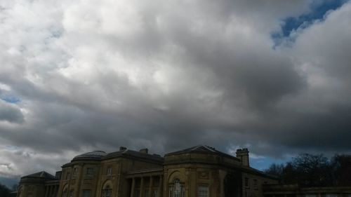 Low angle view of building against cloudy sky