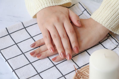 Cropped hands of woman with book
