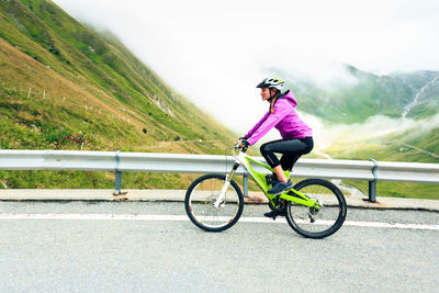 Man riding bicycle on road