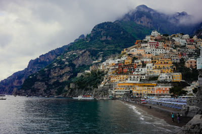 Scenic view of sea and mountains against sky