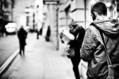 Man looking at city street