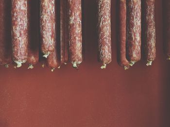 Homemade salami hanging indoors