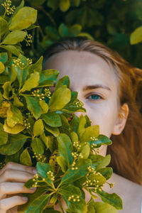 Close-up portrait of girl with leaves