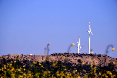 Wind turbines against clear blue sky