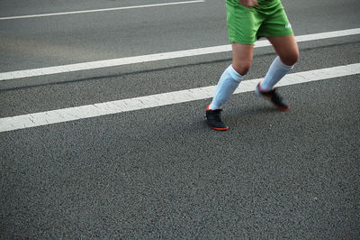 Low section of woman on road