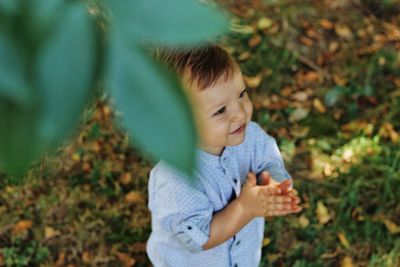 Cute boy holding plant