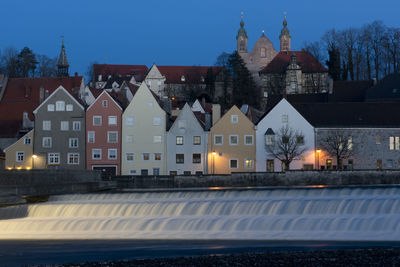 River flowing by houses at night