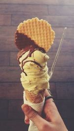 Cropped hand holding ice cream cone