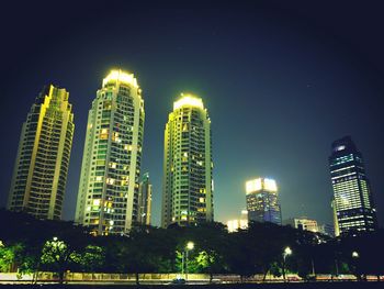 Low angle view of skyscrapers lit up at night