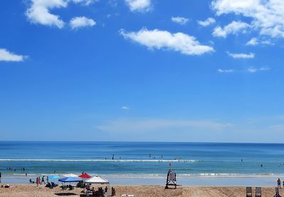 Scenic view of beach against blue sky