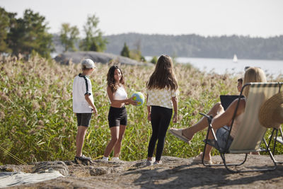 Mother with children relaxing at lake