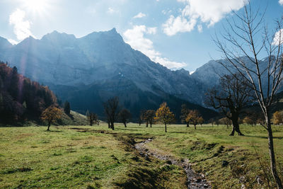 Scenic view of green landscape and mountains against sky