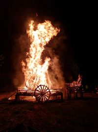 View of fire on field at night
