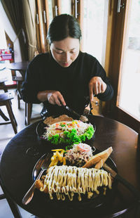Woman holding food on table
