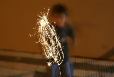 Light painting against defocused boy at night