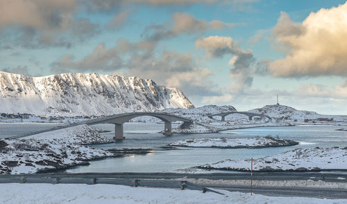Bridge over water against sky during winter